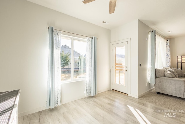 doorway to outside with ceiling fan, a healthy amount of sunlight, and light hardwood / wood-style floors