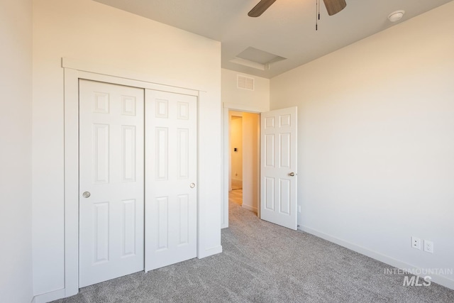 unfurnished bedroom with ceiling fan, a closet, and carpet