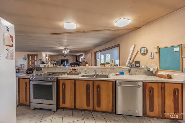 kitchen with light tile patterned flooring, sink, and appliances with stainless steel finishes