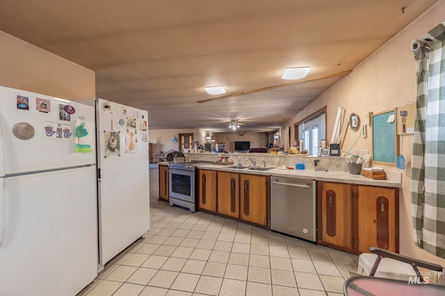 kitchen with tasteful backsplash, sink, and appliances with stainless steel finishes