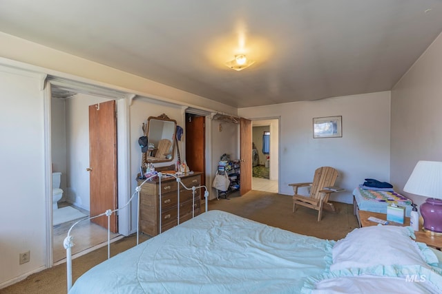 carpeted bedroom featuring connected bathroom