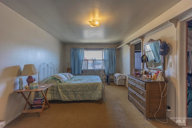 bedroom featuring light colored carpet