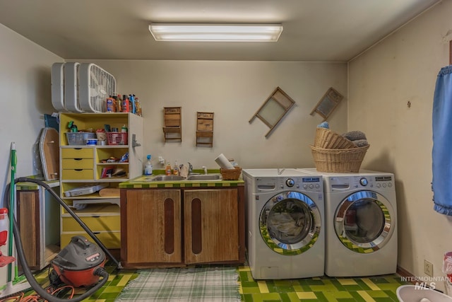 laundry room with cabinets, separate washer and dryer, and sink