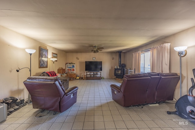 702 N D St, Grangeville, ID 83530 - living area with a wood stove, light tile patterned floors, and ceiling fan