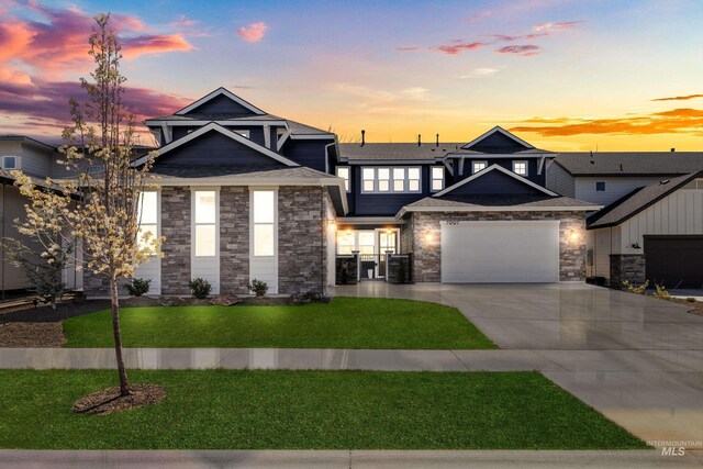 7997 W Suttle Lake Dr, Boise, ID 83714 - view of front of house with concrete driveway, a front yard, a shingled roof, and stone siding