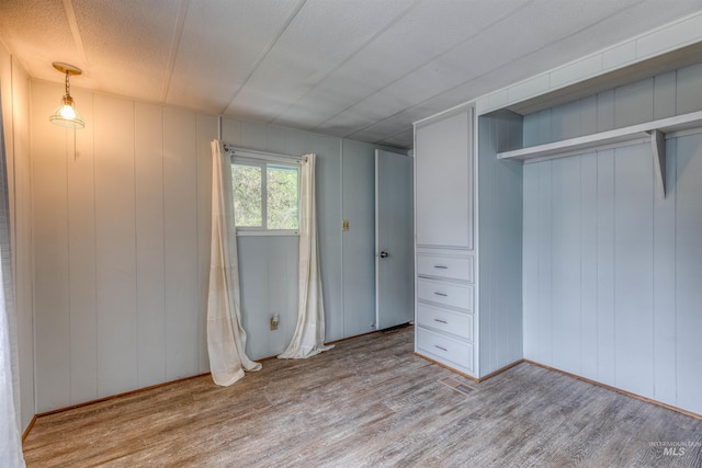 unfurnished bedroom featuring visible vents and wood finished floors