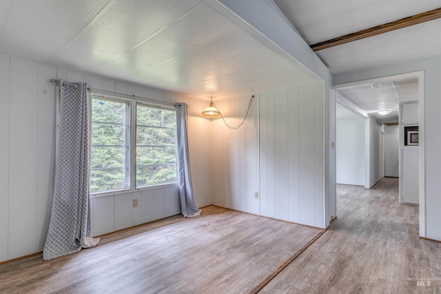 spare room with wood finished floors
