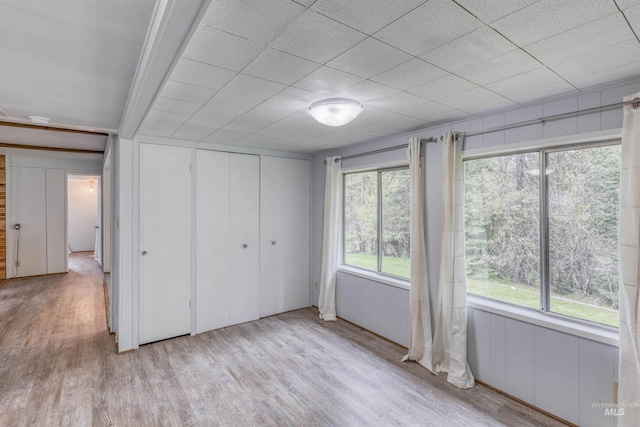 unfurnished bedroom with wood finished floors and a closet