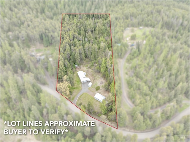 bird's eye view with a wooded view