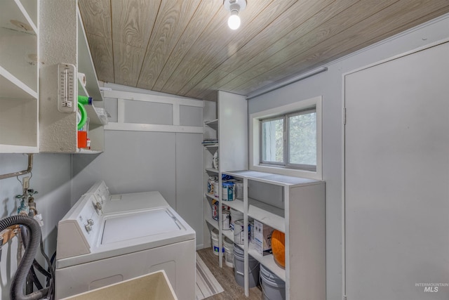 clothes washing area featuring independent washer and dryer, laundry area, wood ceiling, and wood finished floors
