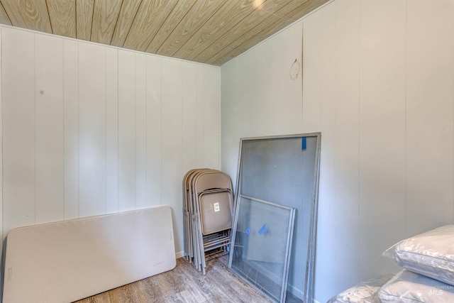 bedroom with wooden ceiling and wood finished floors