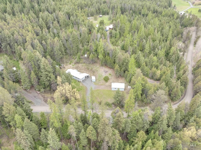 birds eye view of property with a view of trees