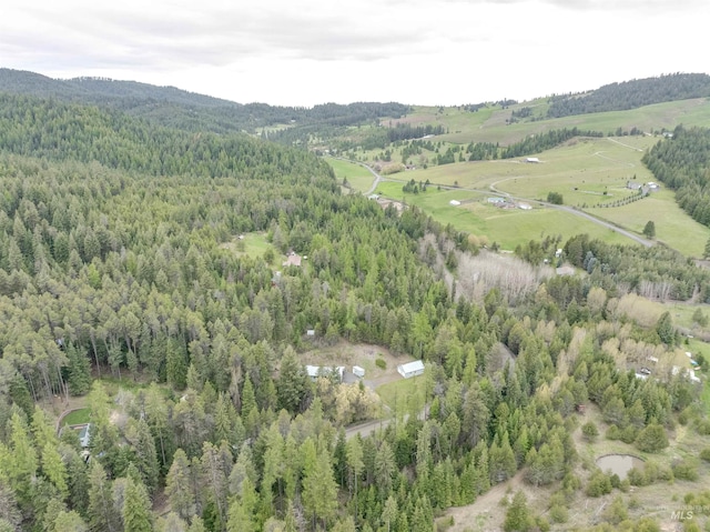 bird's eye view featuring a wooded view