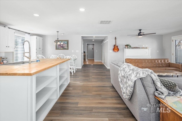 living area featuring visible vents, recessed lighting, dark wood-style flooring, and ceiling fan