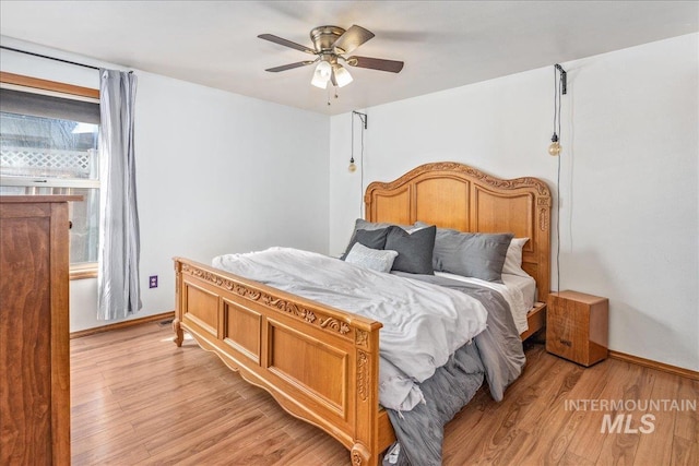 bedroom with baseboards, light wood-style floors, and a ceiling fan