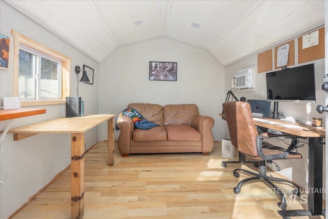 office space with a wall mounted AC, lofted ceiling, and wood finished floors