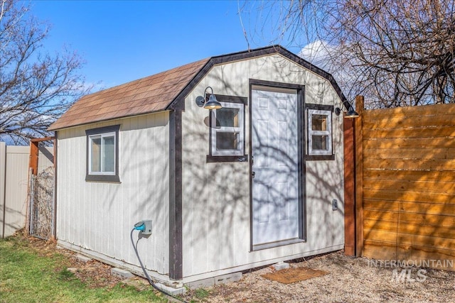 view of shed with fence