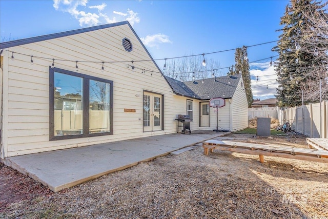 rear view of property with a patio area and fence