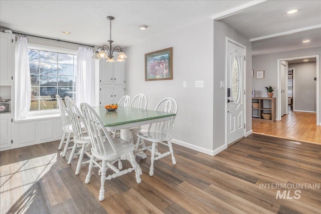 dining space with recessed lighting, wood finished floors, baseboards, and a chandelier