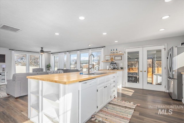 kitchen with visible vents, open shelves, freestanding refrigerator, french doors, and dishwasher