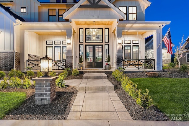 doorway to property featuring a yard and a porch