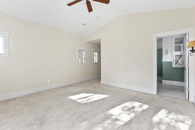 carpeted empty room featuring lofted ceiling and ceiling fan