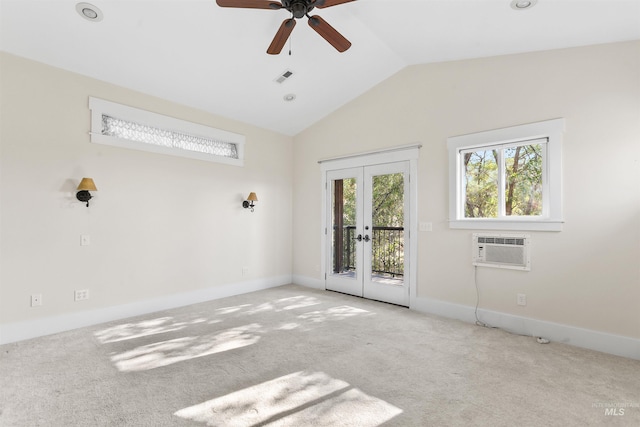 carpeted empty room with french doors, ceiling fan, vaulted ceiling, and a wall mounted AC