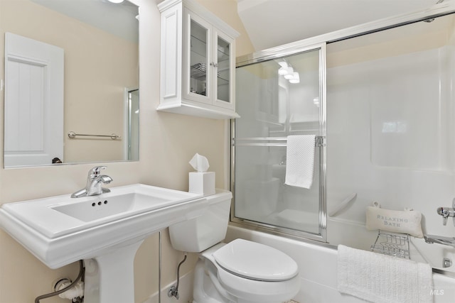 full bathroom with combined bath / shower with glass door, sink, and toilet