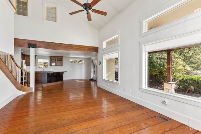 unfurnished living room featuring ceiling fan, hardwood / wood-style floors, and high vaulted ceiling