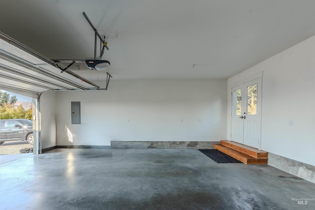 garage with a garage door opener and electric panel