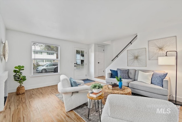 916 N 32nd St, Boise, ID 83702 - living room with wood finished floors, baseboards, and stairway