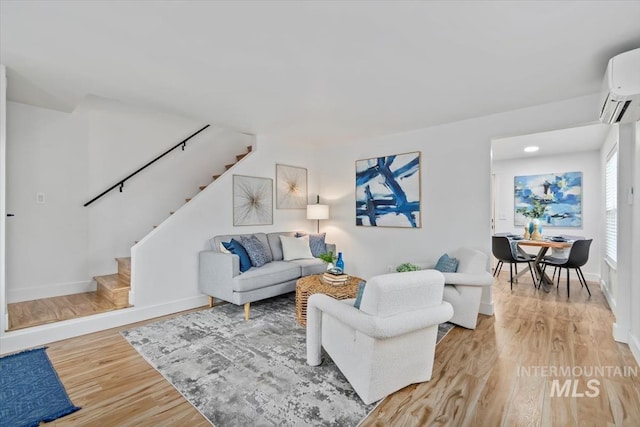 916 N 32nd St, Boise, ID 83702 - living room with baseboards, an AC wall unit, light wood-type flooring, recessed lighting, and stairs