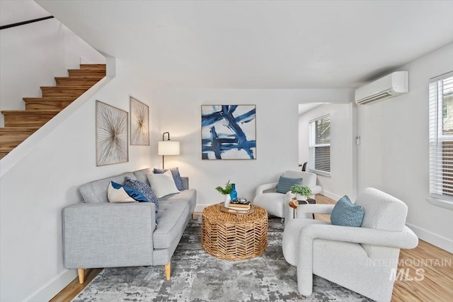 916 N 32nd St, Boise, ID 83702 - living area with baseboards, a wall mounted AC, wood finished floors, and stairs