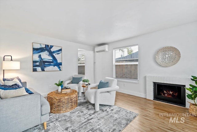 916 N 32nd St, Boise, ID 83702 - living room featuring a wall mounted air conditioner, a brick fireplace, baseboards, and wood finished floors