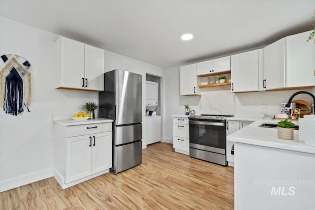 916 N 32nd St, Boise, ID 83702 - kitchen featuring baseboards, light countertops, white cabinetry, stainless steel appliances, and light wood-style flooring