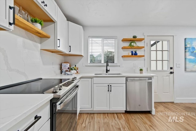 916 N 32nd St, Boise, ID 83702 - kitchen featuring white cabinets, open shelves, a sink, light wood-type flooring, and appliances with stainless steel finishes