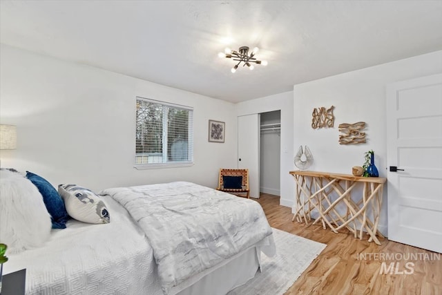 916 N 32nd St, Boise, ID 83702 - bedroom featuring baseboards, a closet, an inviting chandelier, and wood finished floors