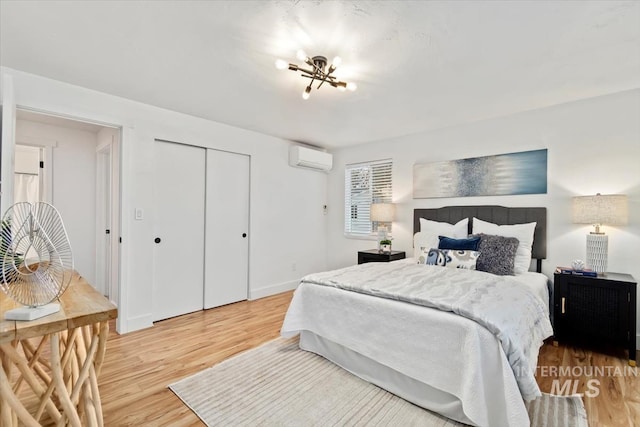 916 N 32nd St, Boise, ID 83702 - bedroom featuring a closet, light wood-style flooring, an AC wall unit, and baseboards