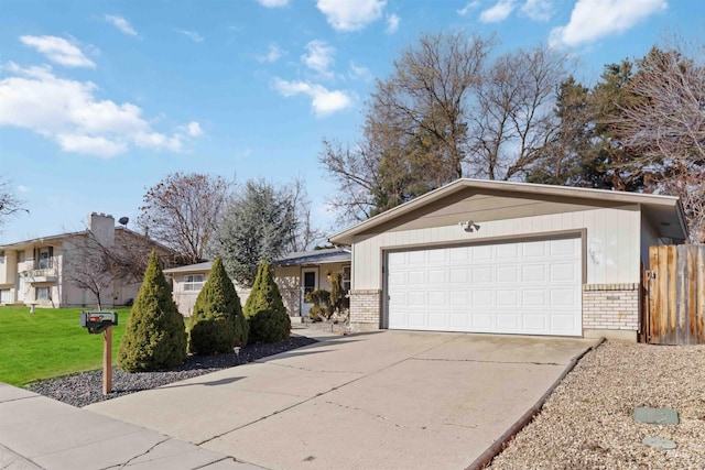 view of front of home featuring concrete driveway, an attached garage, brick siding, and a front yard