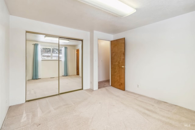 unfurnished bedroom with a closet and carpet