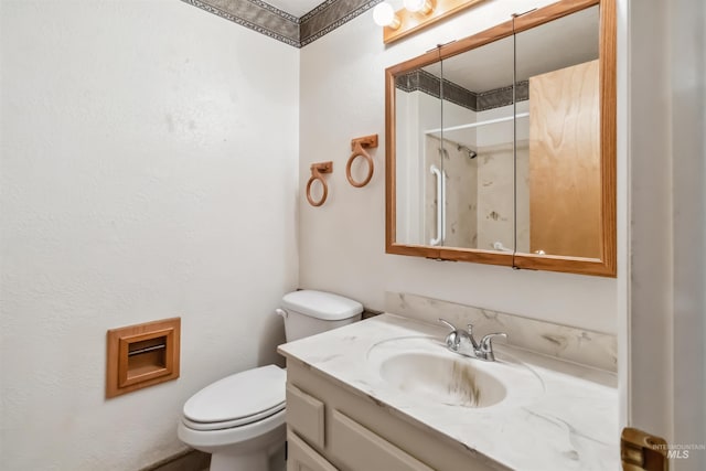 bathroom featuring toilet, walk in shower, and vanity