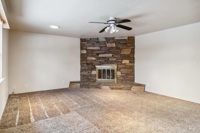 unfurnished living room with carpet flooring, a ceiling fan, and a fireplace