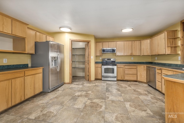 kitchen featuring light brown cabinets and appliances with stainless steel finishes