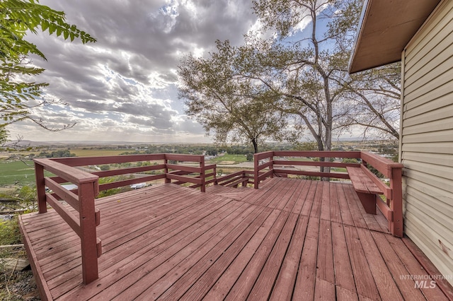 wooden deck with a rural view