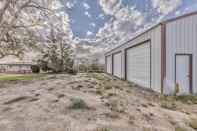 view of yard with an outbuilding and a garage