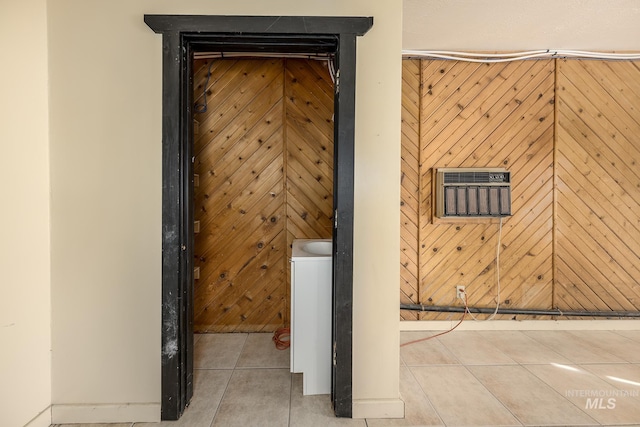 room details featuring wood walls and tile patterned flooring