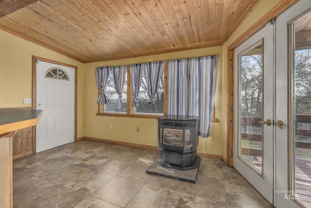 unfurnished sunroom featuring plenty of natural light, a wood stove, and wooden ceiling