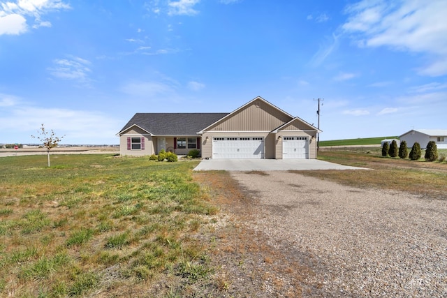 view of front of house with an attached garage, driveway, and a front lawn