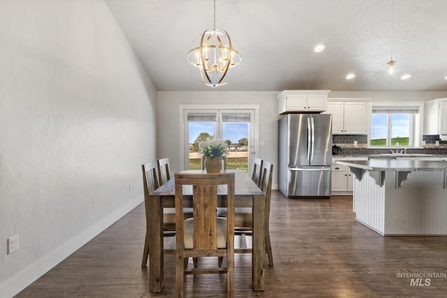dining space featuring an inviting chandelier, a healthy amount of sunlight, dark wood-type flooring, and recessed lighting