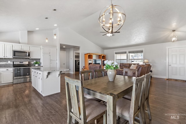 dining space featuring lofted ceiling, a notable chandelier, dark wood-type flooring, and baseboards